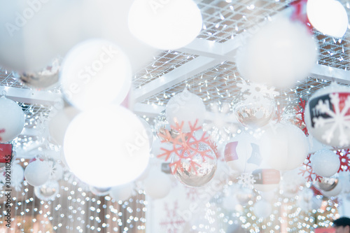 Christmas and new year holiday event with white ornament and lot of small light decorate in party room with soft focus white bokeh background