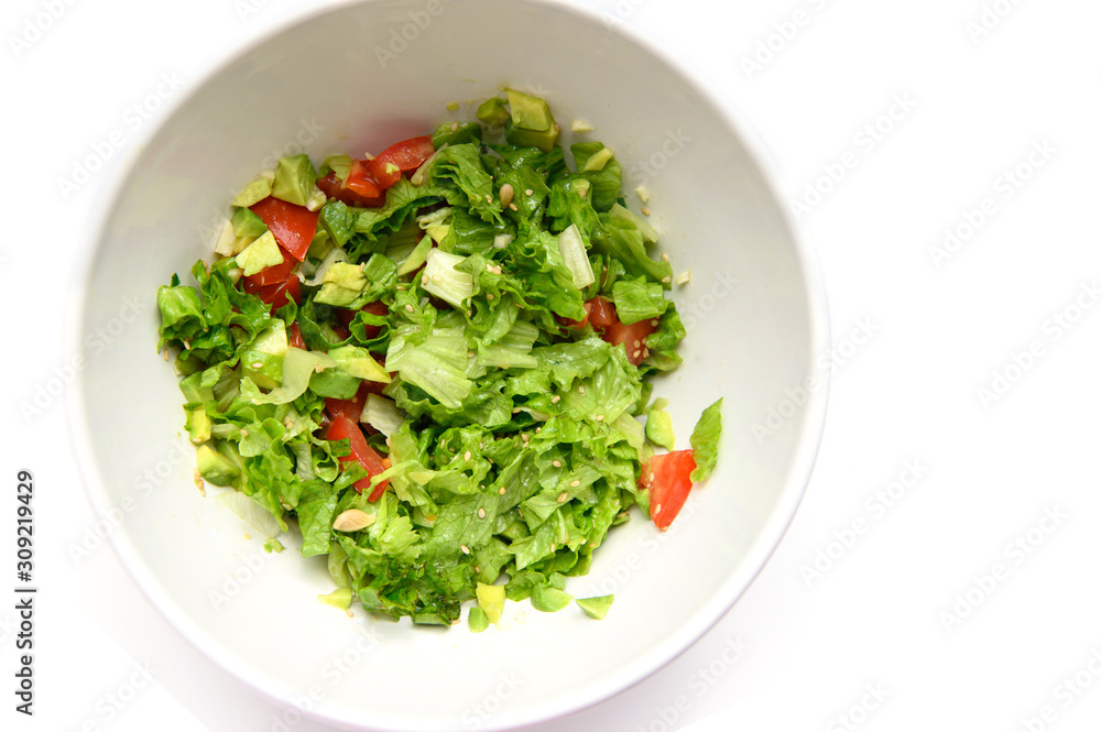 Vegetable salad with avocado, leaves, tomato, sesame seeds, garlic, lemon juice. Vegetable salad with avocado, leaves, tomato, sesame seeds, garlic, lemon juice.