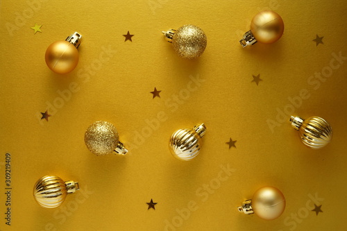 Christmas frame with golden christmas new-year balls and yellow background