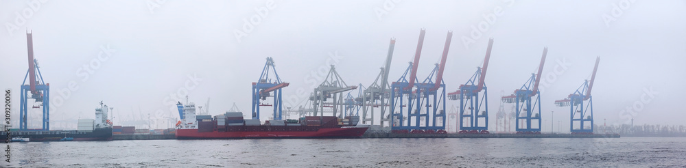 Fototapeta premium Hamburger impressions with the container terminal in the fog.