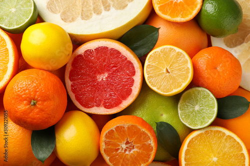 Juicy citrus fruits textured background, close up and top view