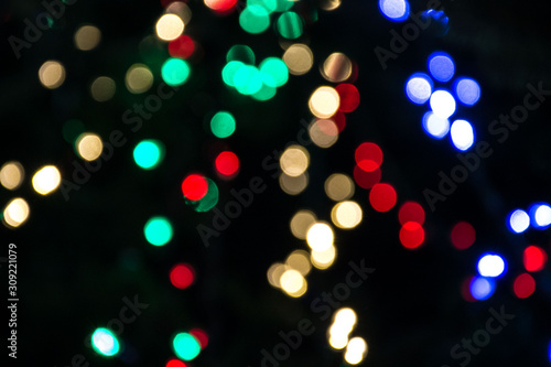 Bright colorful christmas bokeh isolated on black background, Xmas tree light texture, new year holiday decoration