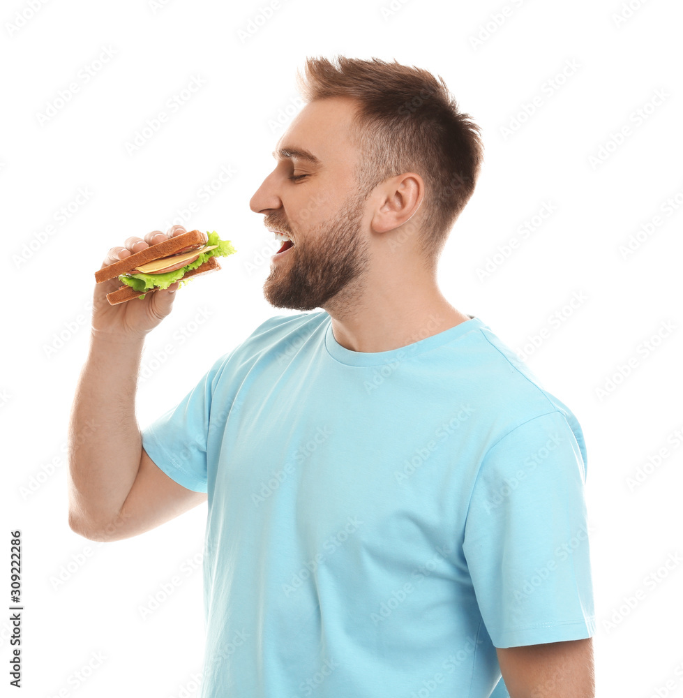 Young man eating tasty sandwich on white background Young man eating tasty sandwich on white background
