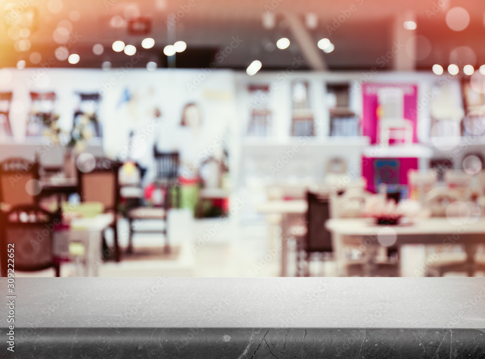 Empty stone surface and blurred view of furniture store in mall. Space for design