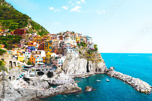 A beautiful landscape of the Manarola village of Cinque Terre located in northern Italy and the blue sea with yachts and boats