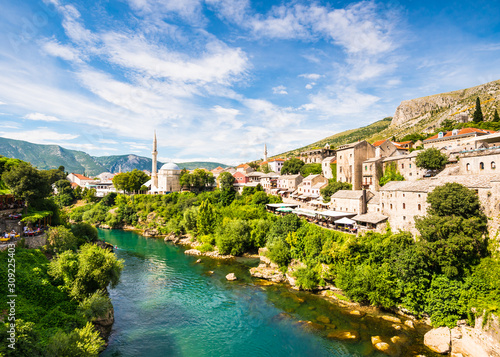 Mostar city on the bank of Neretva river with stone houses and mosques in Bosnia and Herzegovina