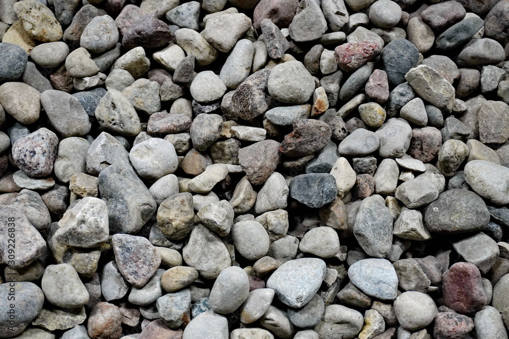 the texture of the stones for intros or background. smooth sea stones and large sharp gravel construction.
