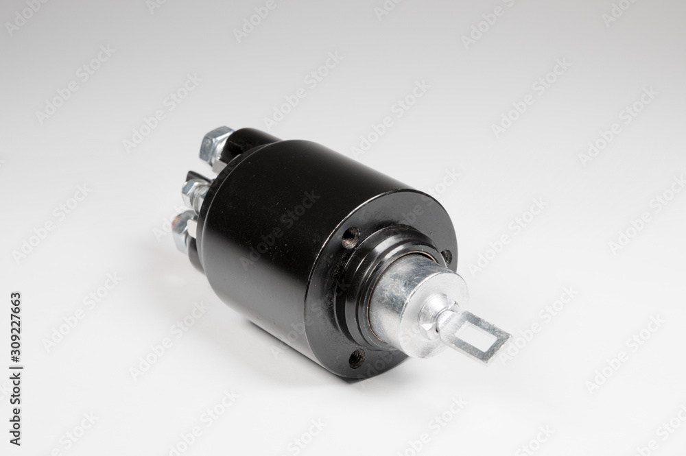 New black solenoid for a starter for a car on a gray gradient background. Auto parts. Starter Parts New black solenoid for a starter for a car on a gray gradient background. Auto parts. Starter Parts