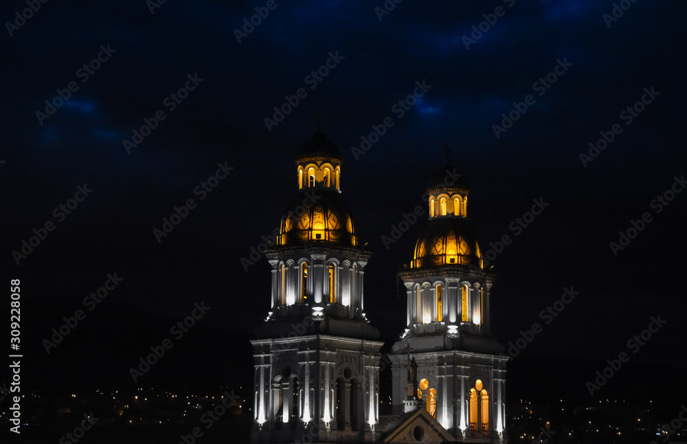 Church towers illuminated at night