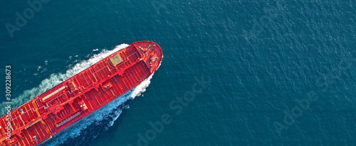 Aerial drone ultra wide panoramic photo of industrial fuel and petrochemical tanker ship cruising open ocean deep blue sea photo