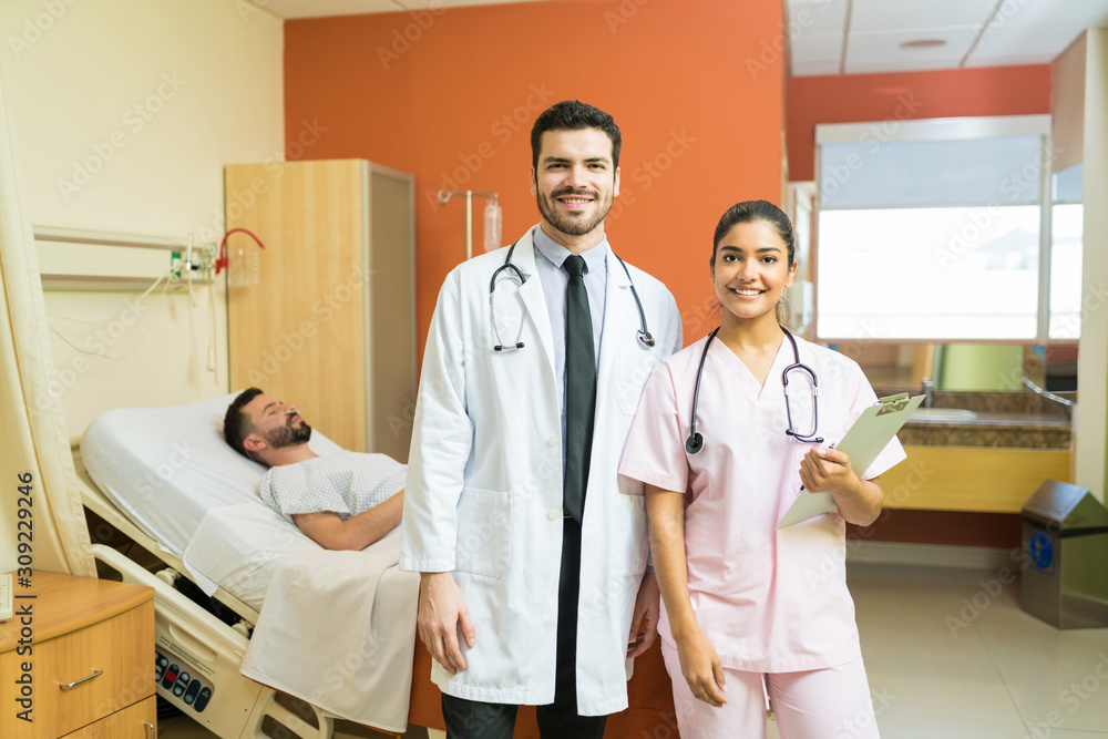 Fototapeta premium Confident Medical Team Against Patient In Hospital