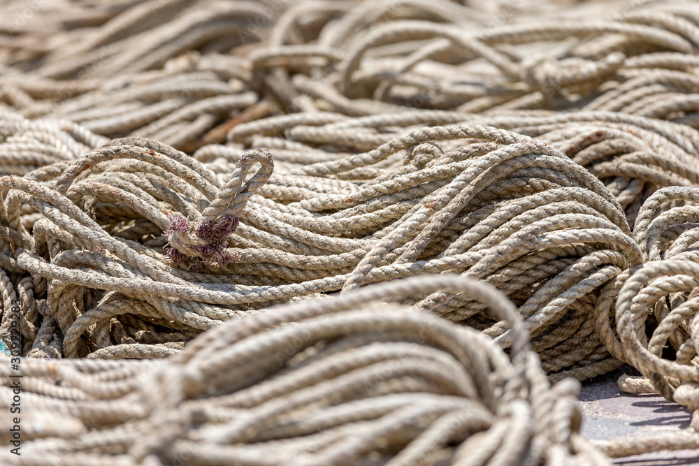 Old heavy duty rope laying outside on the asphalt