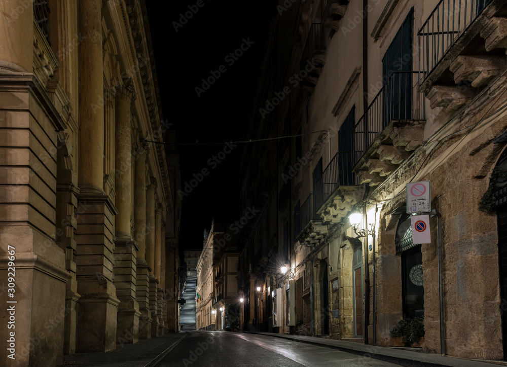 Narrow street of the sicilian ceramic city Caltagirone at night, Sicily, south Italy