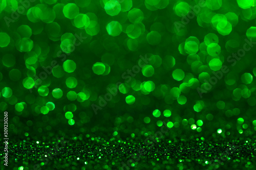 Christmas abstract texture, green sparkles bokeh shining background.