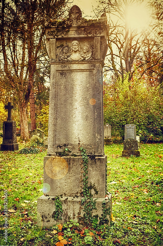 Munich, autumnal view with beautiful colors of Alter Nordfriedhof (old cemetery North), a dismiss graveyard now public park and green space for jogging and relax in the heart of the city © acrogame