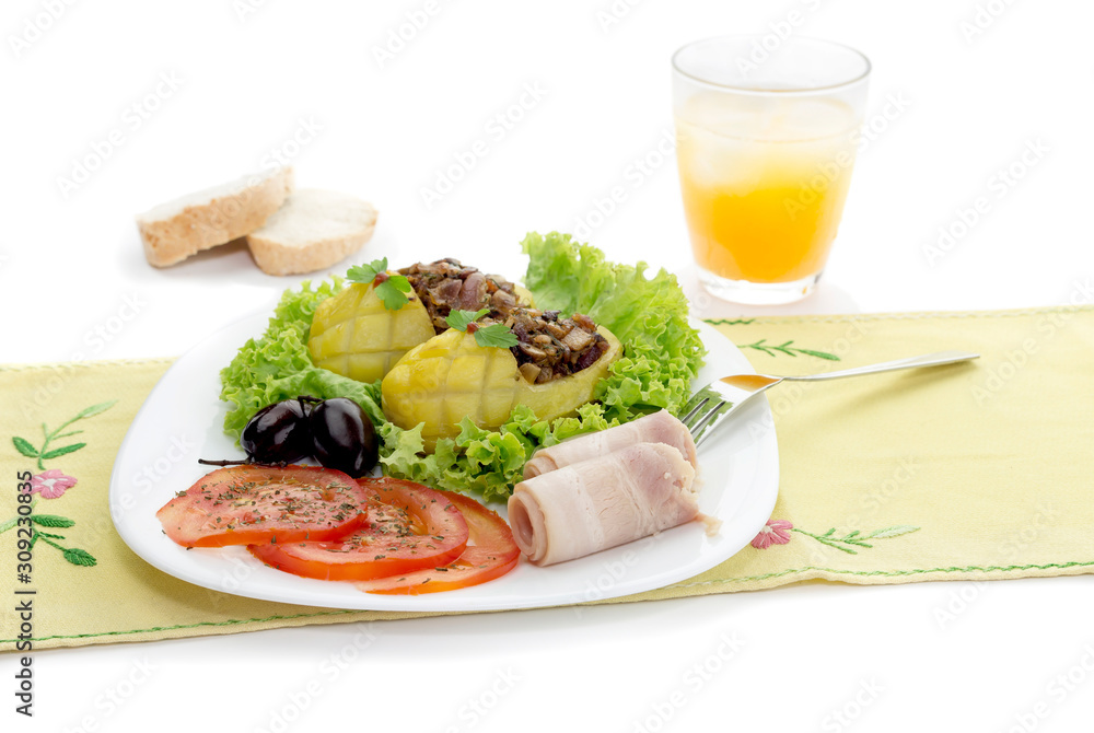 Children's meal - stuffed with potatoes, vegetables and bacon on the table close-up