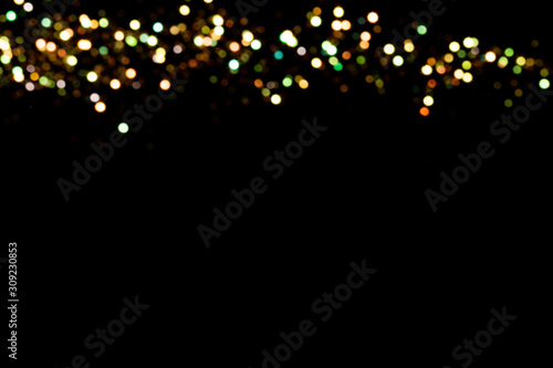 Gold glitter bokeh lights on black background, unfocused. Holiday time. overlay layer