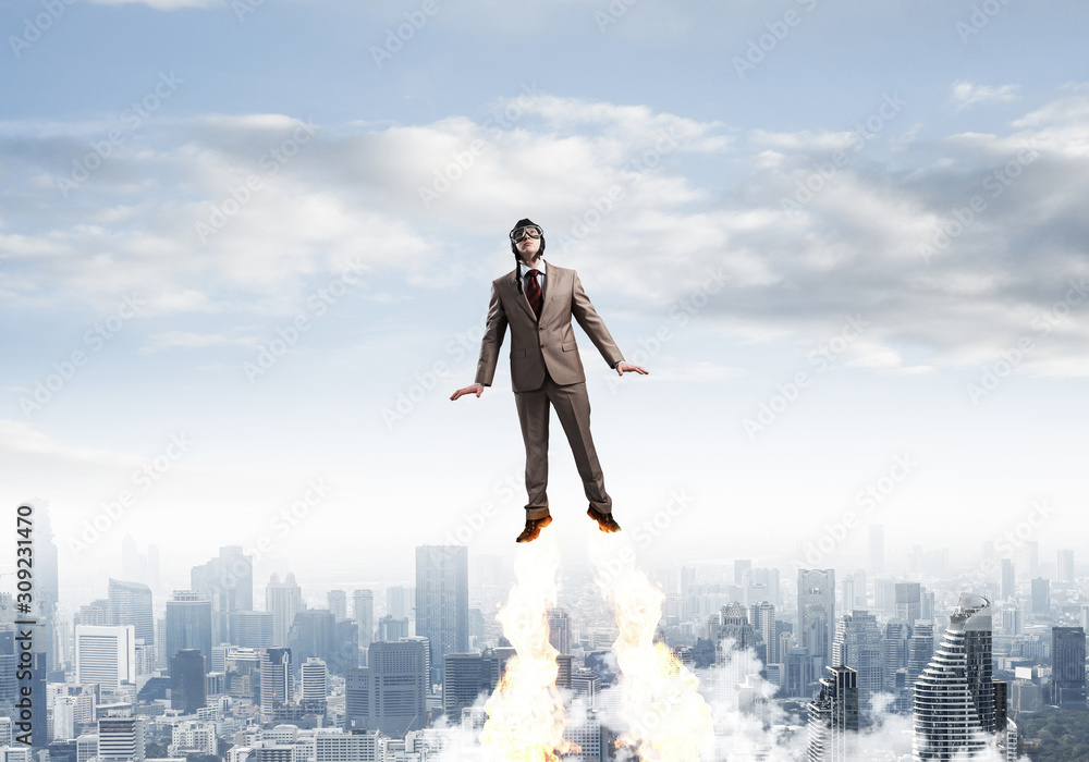 Businessman in suit and aviator hat flying in sky Businessman in suit and aviator hat flying in sky