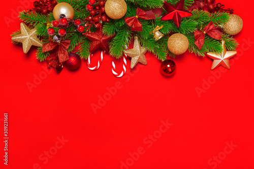 Christmas red background with herringbone and decor. Gold and red jewelry. Top view with space for copy.