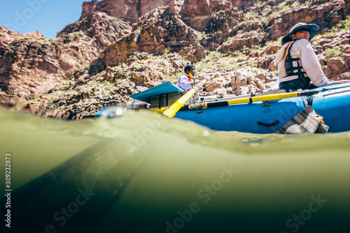 A man rows a raft  on the Colorado River, Grand Canyon National Park, Arizona, USA photo