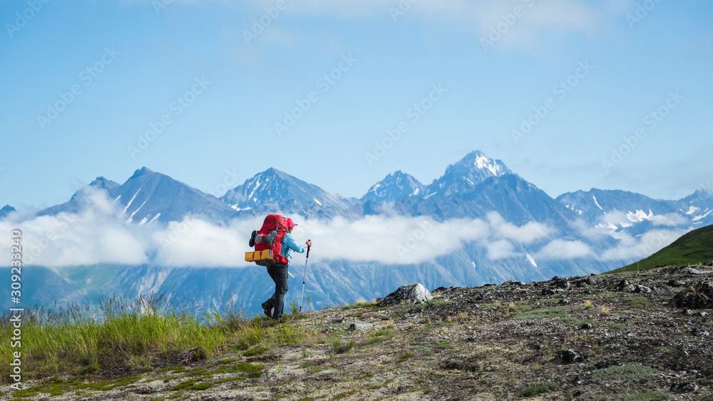 A woman hiking in Lake Clark National Park and Preserve, Alaska, USA A woman hiking in Lake Clark National Park and Preserve, Alaska, USA