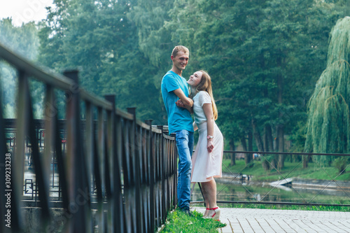 A guy and a girl are walking in the park © Volodya