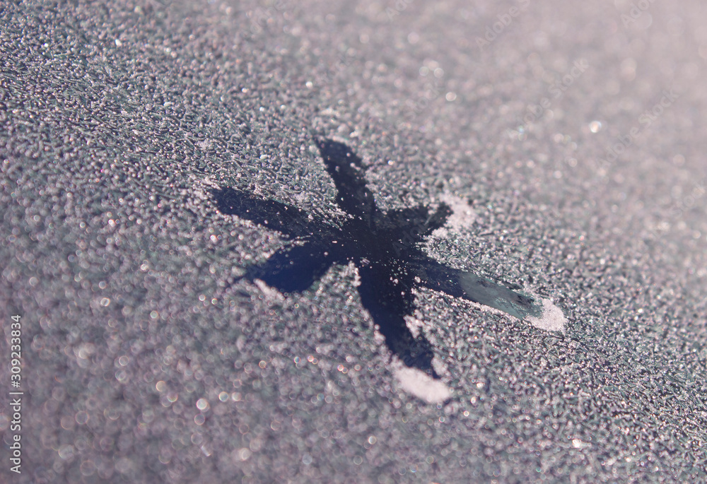 Snowflake painted on frozen window. A patterned snowflake is drawn with a finger on the hoarfrost. Snowflake on winter window Snowflake painted on frozen window. A patterned snowflake is drawn with a finger on the hoarfrost. Snowflake on winter window