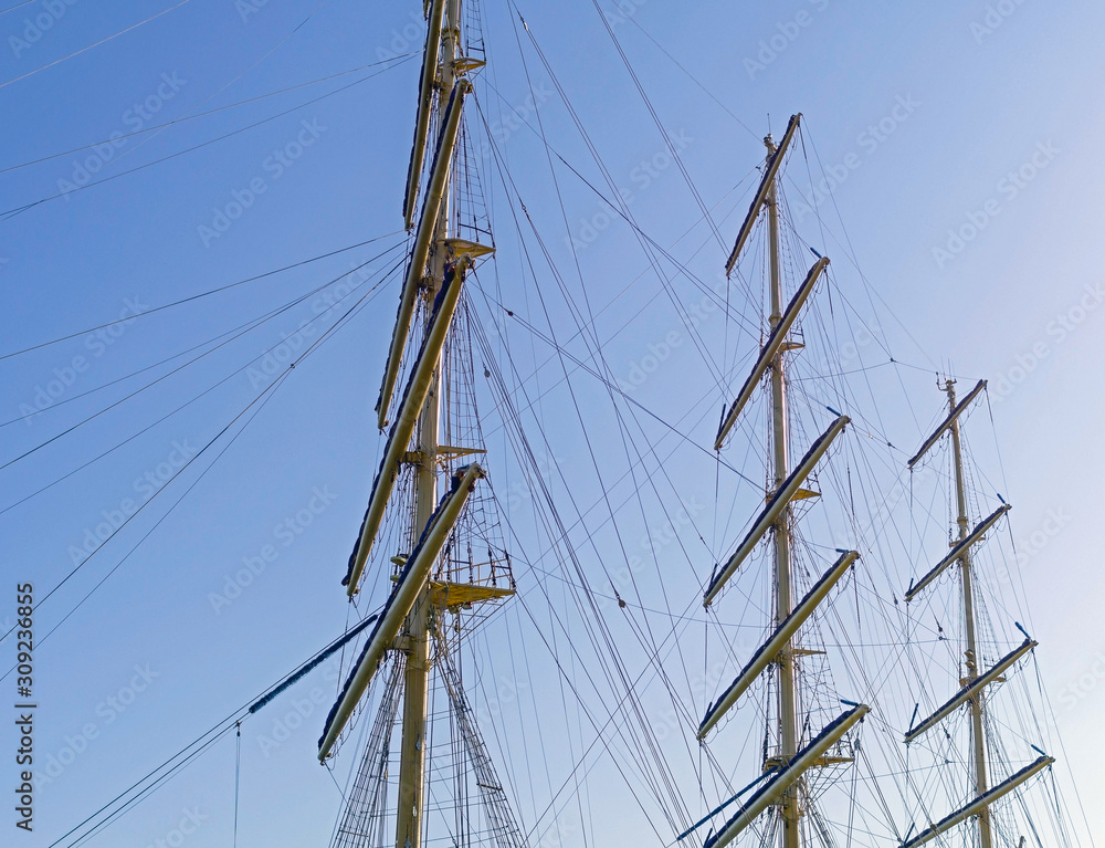 Masts and rigging of a sailing ship against sky Masts and rigging of a sailing ship against sky