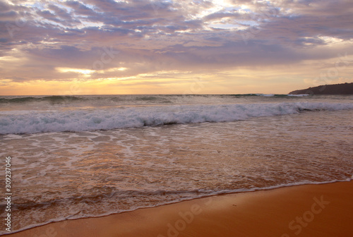 Beautiful sunset on the beach. The surf pounds the shore. Phuket, Thailand