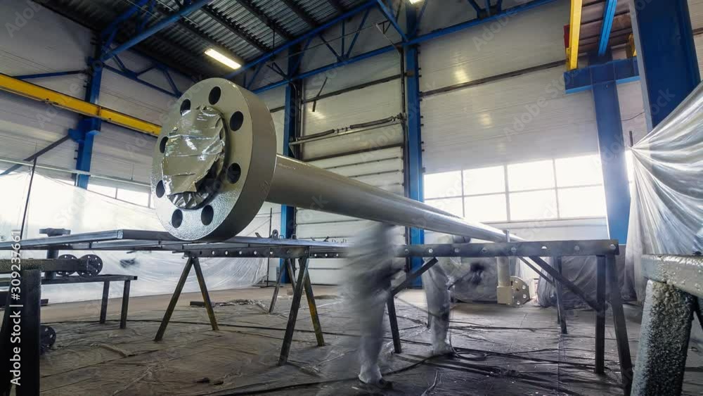 worker paints large pipe with sprayer in workshop timelapse worker paints large pipe with sprayer in workshop timelapse
