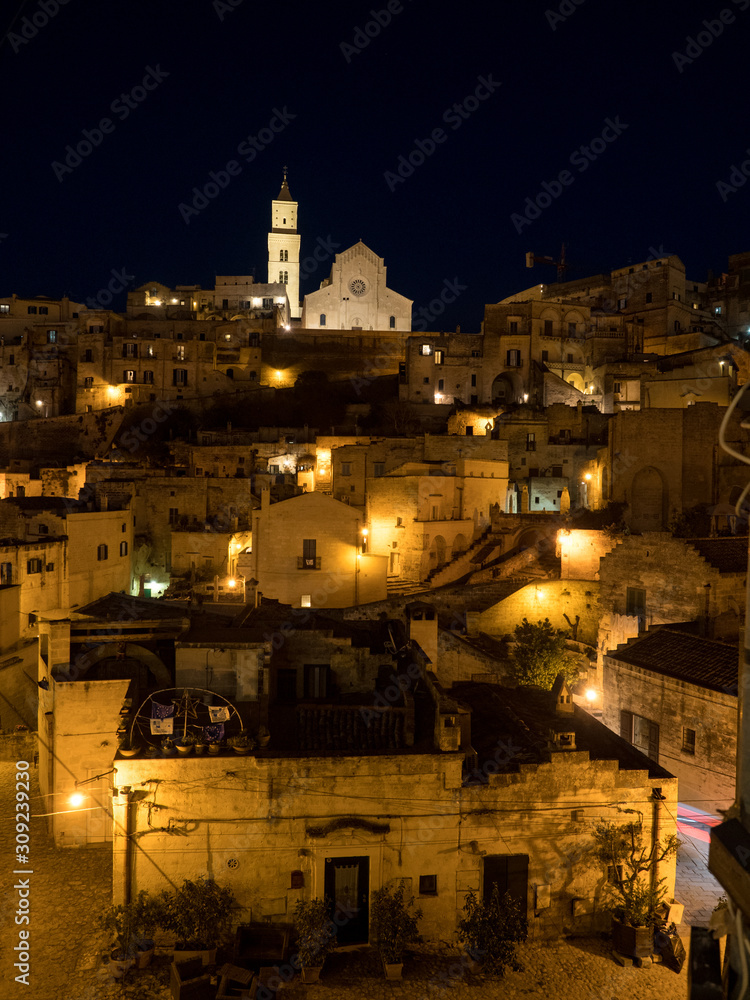Italy, april 2019: Sassi is an ancient district of Matera by night, landscape by night, night lights Italy, april 2019: Sassi is an ancient district of Matera by night, landscape by night, night lights