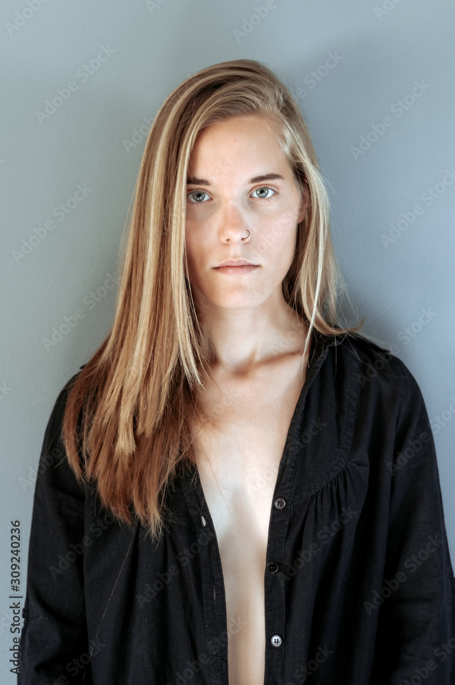 Young blonde woman, with black shirt, photographed at home Young blonde woman, with black shirt, photographed at home