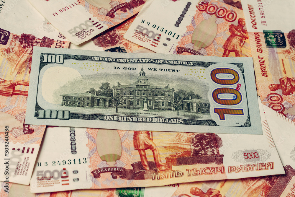 one hundred dollar bill lies on 5000 Russian rubles, the side where the hall of independence is depicted. 2019 one hundred dollar bill lies on 5000 Russian rubles, the side where the hall of independence is depicted. 2019