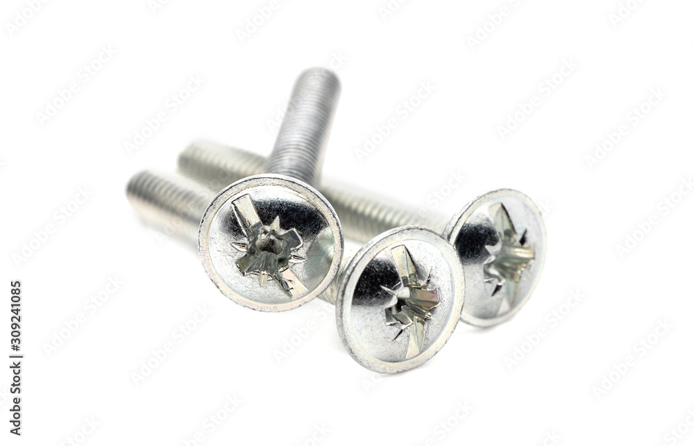 Stainless steel machine screws isolated on a white background. Metal screws close-up, selective focus. Stainless steel machine screws isolated on a white background. Metal screws close-up, selective focus.