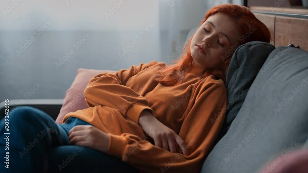 tired teenage girl sleeping while sitting on couch tired teenage girl sleeping while sitting on couch