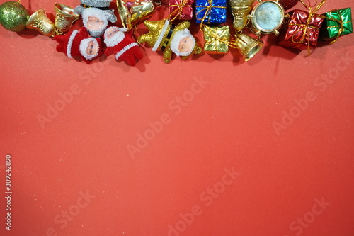 Christmas red background with herringbone and decor. Gold jewelry.