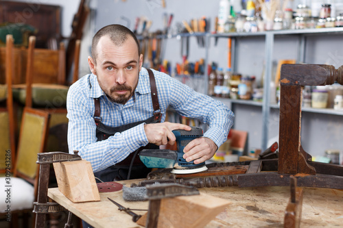 Craftsman repairing antique furniture