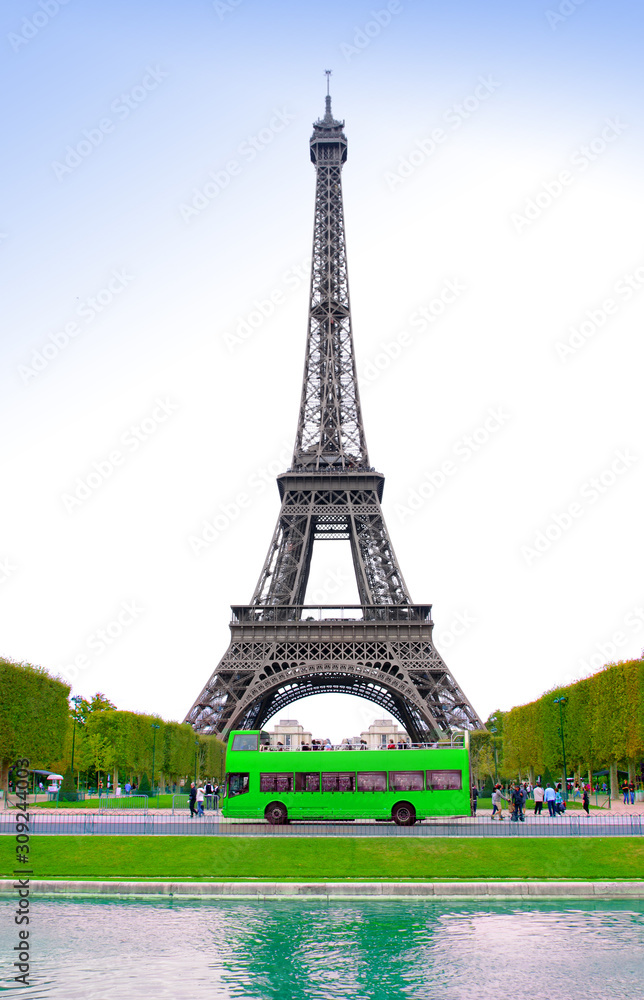 view of Eiffel Tower and green bus with tourists visiting Paris city
