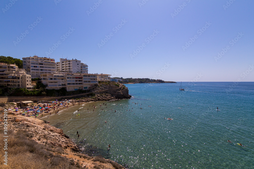 People having fun at Cala Llenguadets beach in Salou, a famous tourist destination at summer in Spain