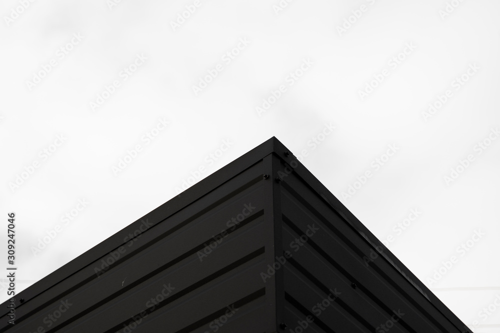 Black Corrugated metal sheet texture surface of the wall. Galvanize steel background. Black Corrugated metal sheet texture surface of the wall. Galvanize steel background.