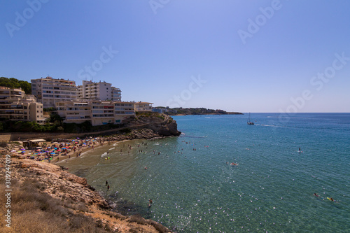 People having fun at Cala Llenguadets beach in Salou, a famous tourist destination at summer in Spain photo