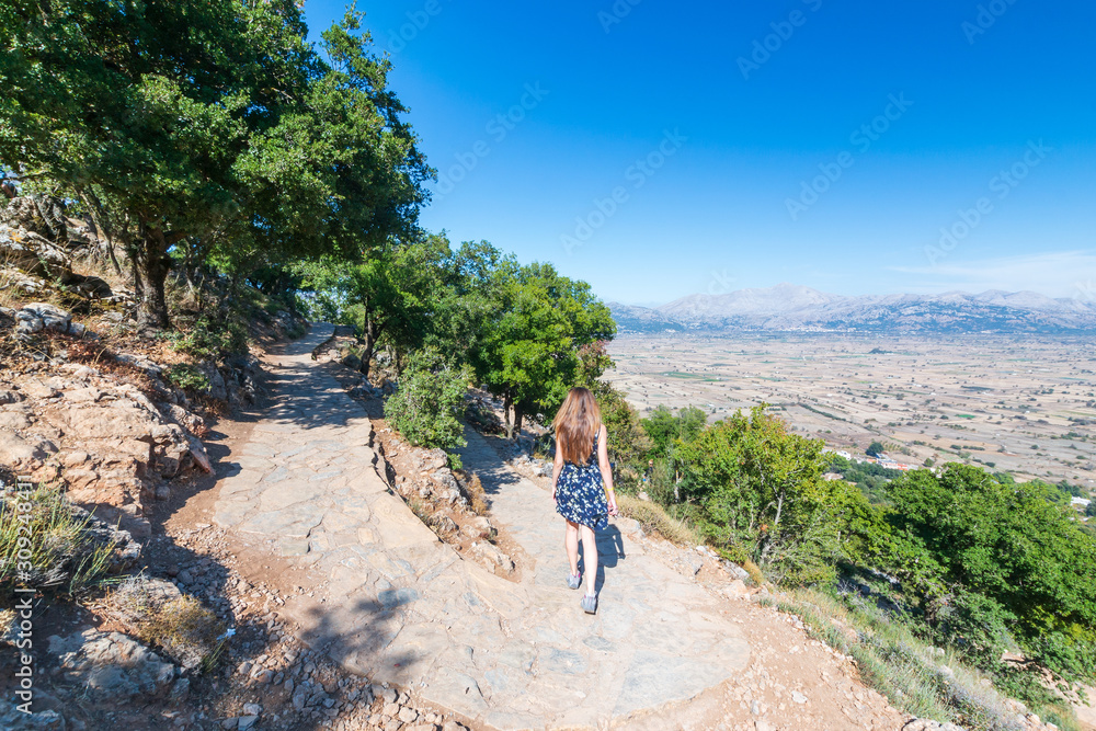Girl tourist go from the Dikteo Andro Cave also known as birth place of Zeus in Crete