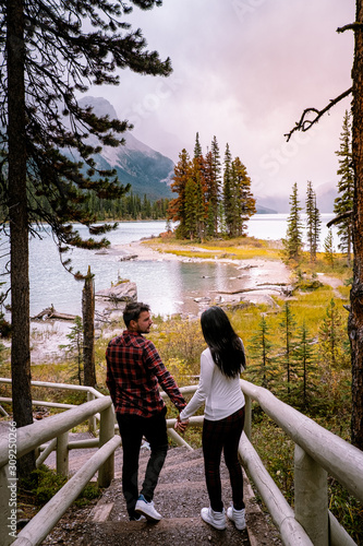 couple visit Maligne lake Jasper Alberta Canada during late Autumn in October