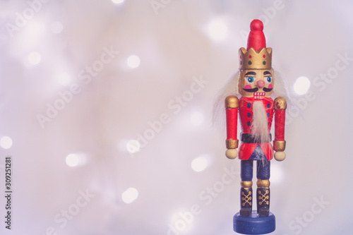 Wooden Nutcracker soldier Christmas decoration with sparkling  in background