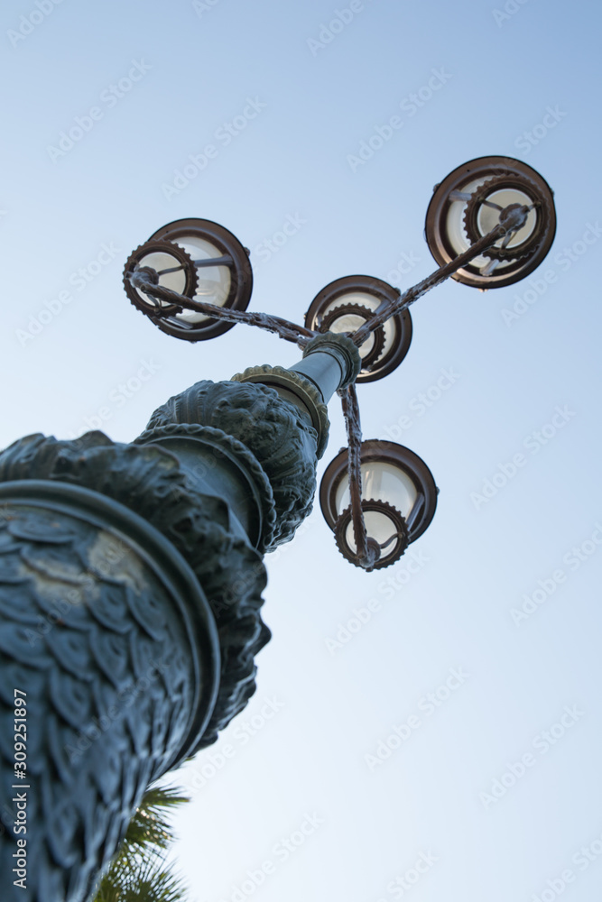 Vintage street light.black street lamp in an open blue sky . Street