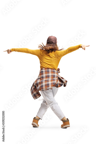Rear view shot of a young female in casual clothing dancing