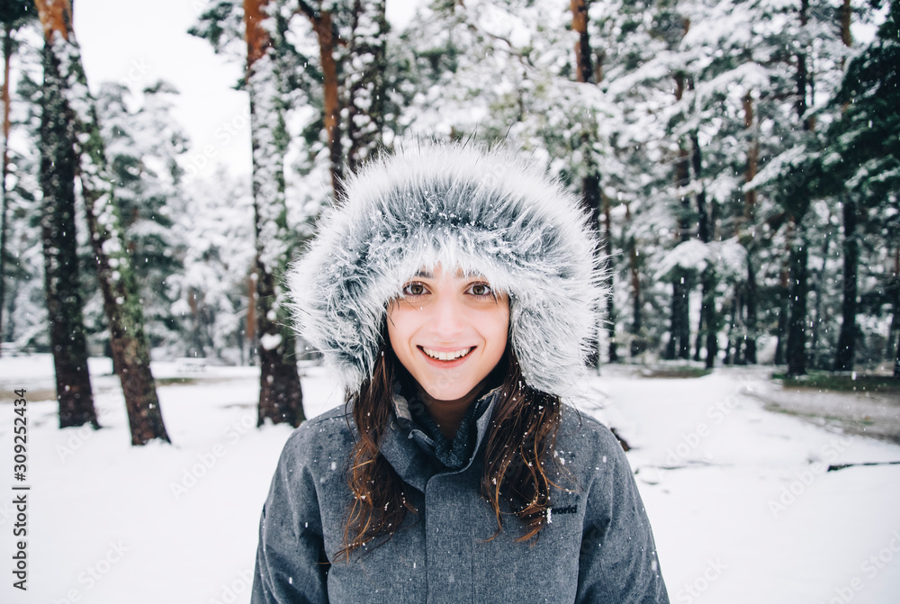 Portrait of happy young woman in winter forest Portrait of happy young woman in winter forest
