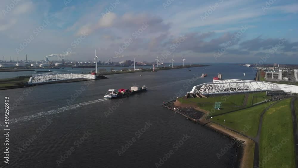 aerial view of a container ship passing the Maeslant Storm Surge Barrier in The Netherlands aerial view of a container ship passing the Maeslant Storm Surge Barrier in The Netherlands