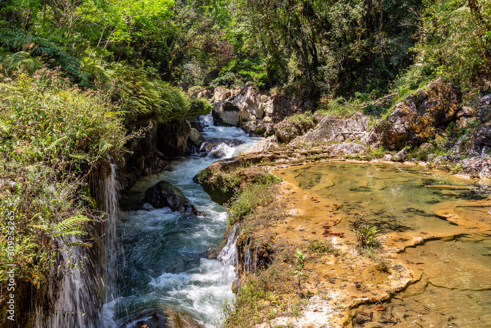Panorama of the limestone ridge with cascades and waterfalls of Semuc Champey in the Peten jungle and rainforest of Guatemala.
