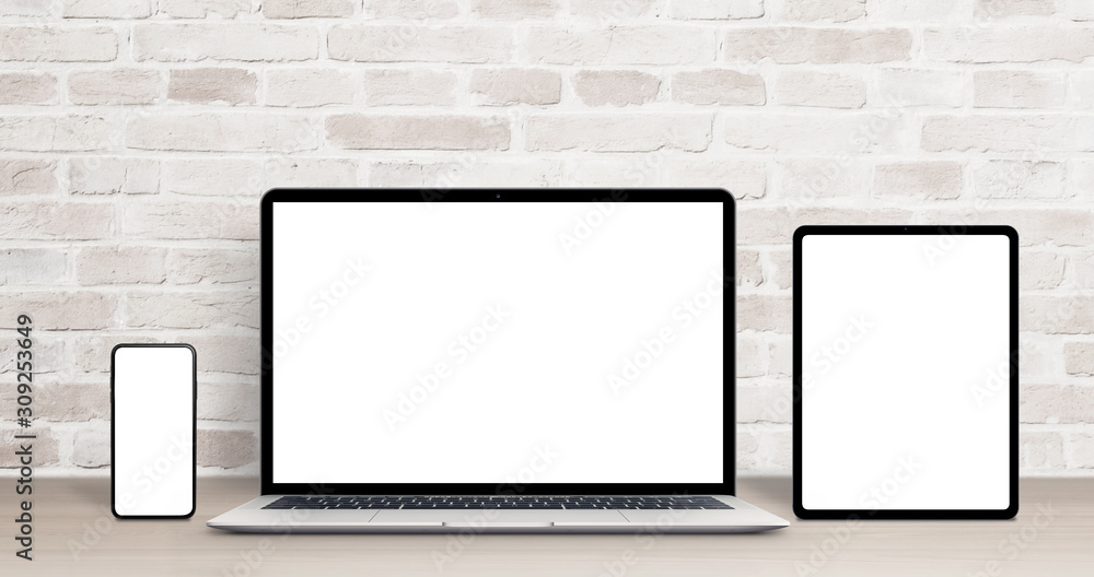 Laptop, tablet and phone mockup on work desk. Modern devices with thin, round edges. Isolated screens for app or web site presentation. Brick wall in background Laptop, tablet and phone mockup on work desk. Modern devices with thin, round edges. Isolated screens for app or web site presentation. Brick wall in background